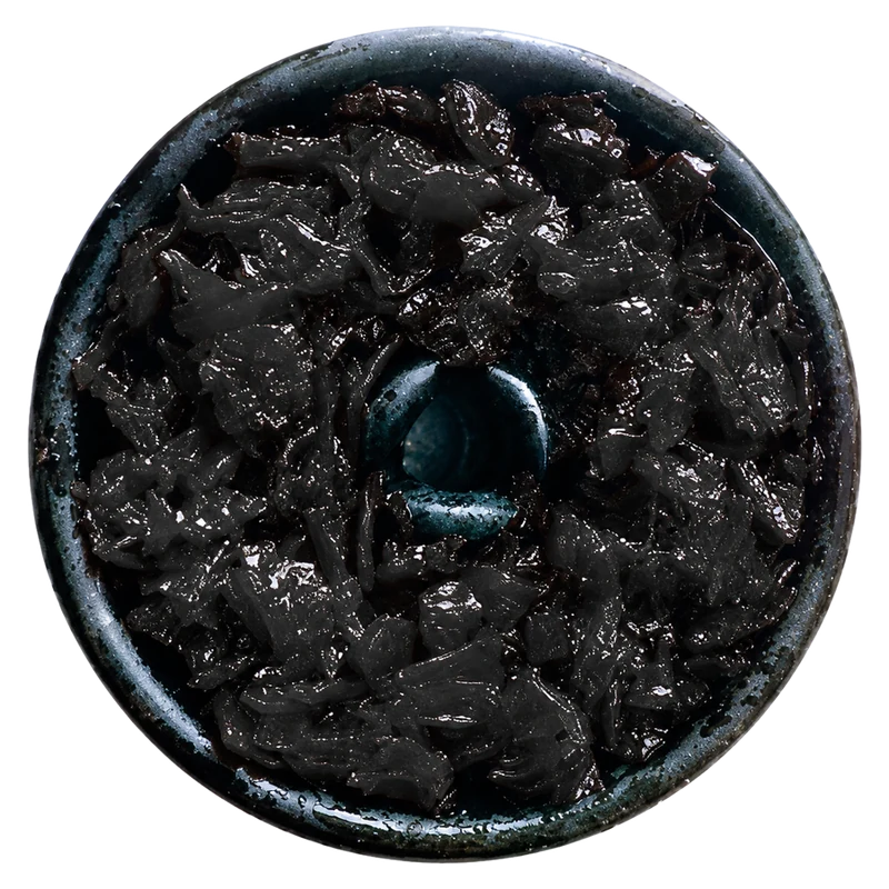 Dark leaf tobacco in a clay bowl